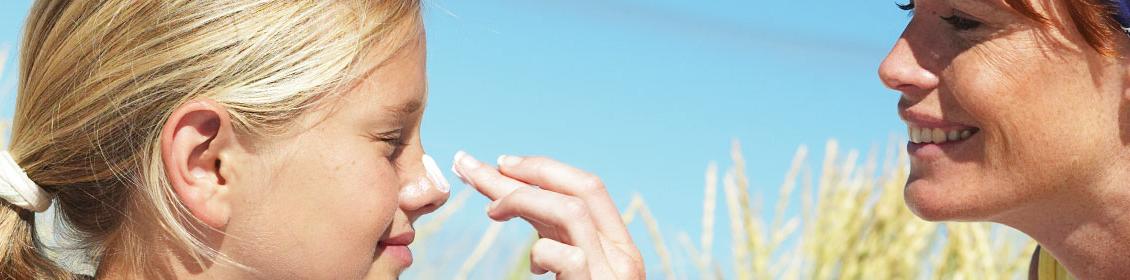 Woman applying cream on a child